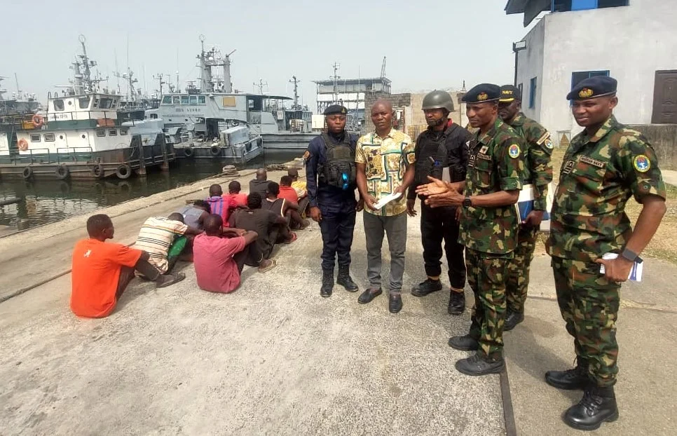 Based Operations Officer, Nigeria Navy Ship, NNS Pathfinder, Port-Harcourt, Cdr. Said Kabir handling over the suspects oil thieves to the NSCDC in Port-hacourt