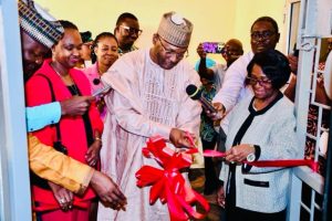 Prof Yakubu cutting the ribbon to declare open the NEC IT Workplace