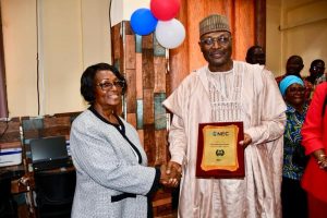 Prof Yakubu receiving the plaque of honour from NEC Chair Davidatta Browne Lansanah