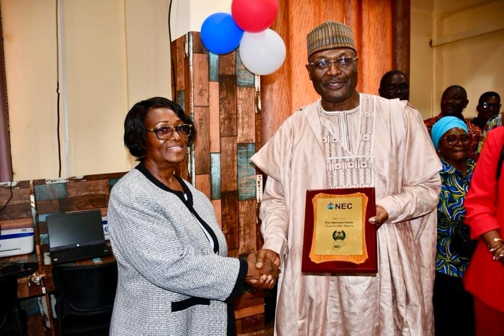Prof Yakubu receiving the plaque of honour from NEC Chair Davidatta Browne Lansanah