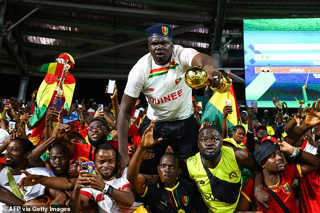 Guinea fans celebrating their AFCON match victory against Gambia
