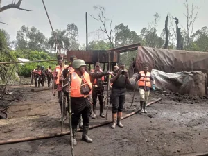Commander of NNS Pathfinder Commodore Desmond Igbo taking newsmen around illegal refinery in Rivers