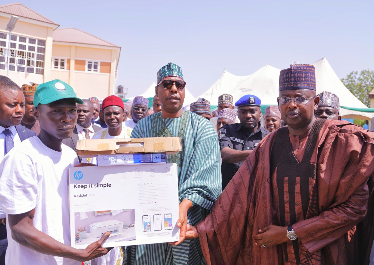 Governor Zulum presenting kits to one of the beneficiaries