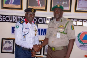 L-R: FCT NSCDC Commandant, Olusola Odumosu and FCT Correctional Service Comptroller, John Francis
