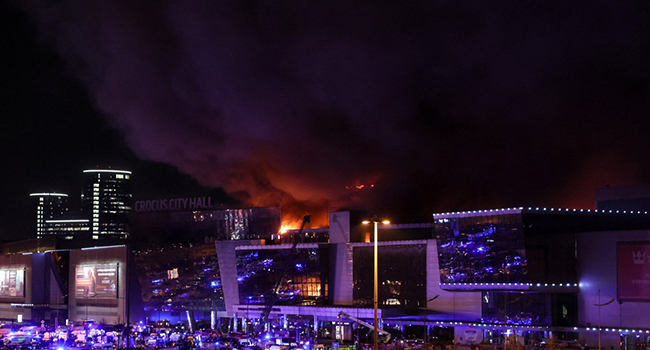 A view shows the burning Crocus City Hall concert hall following the shooting incident in Krasnogorsk, outside Moscow, on March 22, 2024. (Photo by STRINGER / AFP)