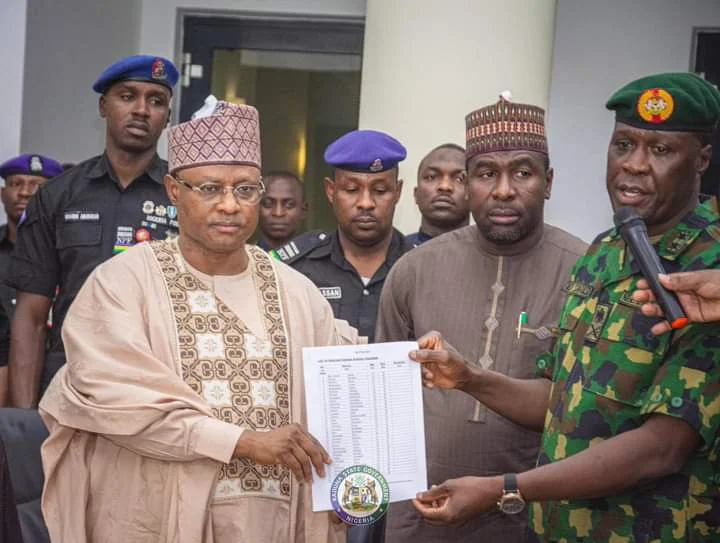 From the right the General Officer Commanding 1 Division Nigerian Army, Maj.-Gen. Mayirenson Saraso, presenting the rescued school children of Kuriga to Gov. Uba Sani on Monday.