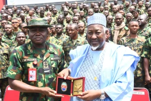 The Commandant, Armed Forces Command and Staff College (AFCSC), presenting a plaque to the Minister of Defence, Muhammad Badaru on Tuesday in Kaduna