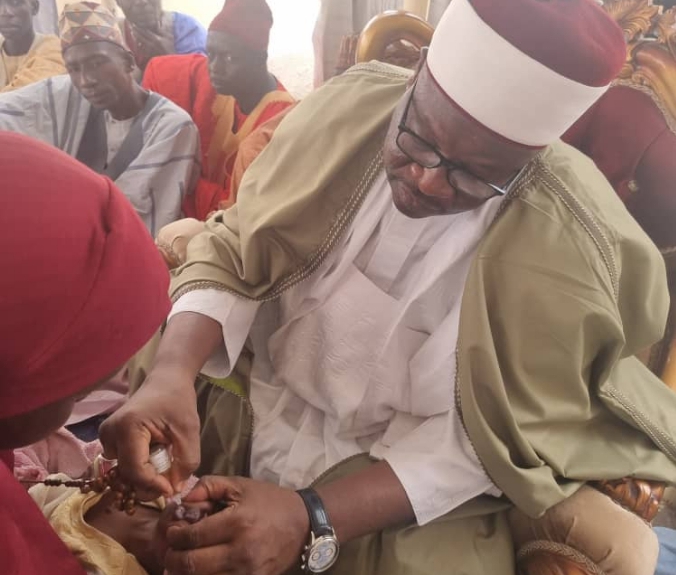 Shehu of Dikwa, Alhaji Ibrahim Ibn Umar Ibrahim El-kanemi, administering a polio vaccine to a child in Dikwa LGa of Borno State