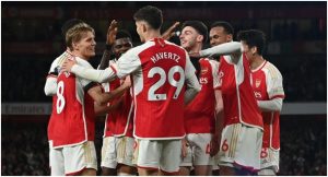 Arsenal’s English defender #04 Ben White celebrates with teammates after scoring their fifth goal during the English Premier League football match between Arsenal and Chelsea at the Emirates Stadium in London on April 23, 2024. (Photo by Glyn KIRK / AFP) /