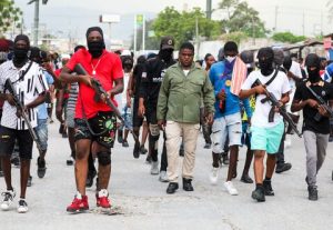 Former police officer Jimmy "Barbecue" Cherizier, leader of the 'G9' coalition, leads a march surrounded by his security against Haiti's Prime Minister Ariel Henry, in Port-au-Prince, Haiti.