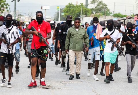 Former police officer Jimmy "Barbecue" Cherizier, leader of the 'G9' coalition, leads a march surrounded by his security against Haiti's Prime Minister Ariel Henry, in Port-au-Prince, Haiti.