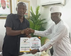 Mr William Moses, National Organising Secretary , Young Progressives Party (YPP) presenting Nomination and Expression of Interest Forms to Mr John Akinmurele in Abuja