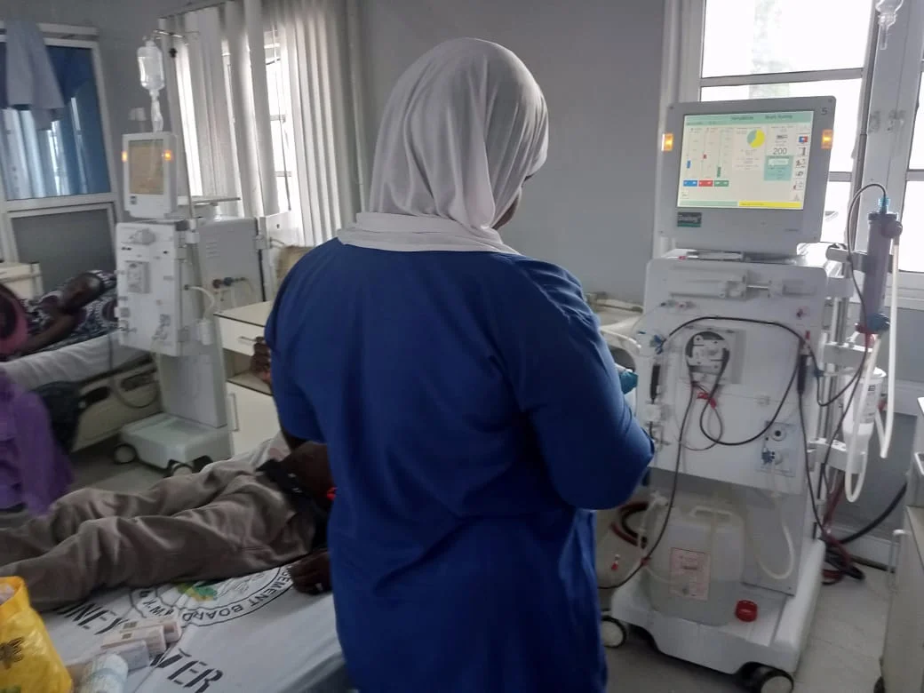 A medical staff attending to a patient inside the dialysis centre