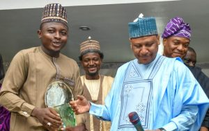 A reporter with Daily Nigeria, Umar Audu and Minister of Information, Mohammed Idris