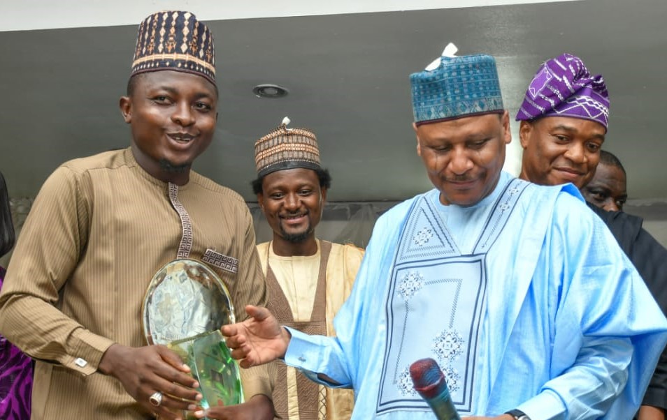 A reporter with Daily Nigeria, Umar Audu and Minister of Information, Mohammed Idris