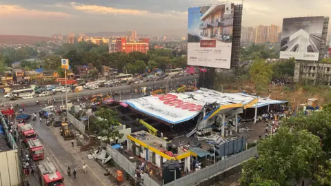 The vast advert fell on top of a petrol station and some houses in Ghatkopar, a suburb of Mumbai