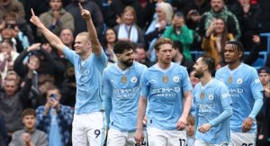 Manchester City’s Norwegian striker #09 Erling Haaland (L) celebrates with teammates after scoring their third goal and his hattrick goal from the penalty spot during the English Premier League football match between Manchester City and Wolverhampton Wanderers at the Etihad Stadium in Manchester, north west England, on May 4, 2024. (Photo by Darren Staples / AFP)