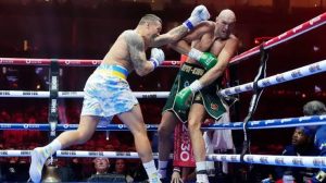 Usyk punches Fury during the fight. Photo: Fayez NURELDINE / AFP