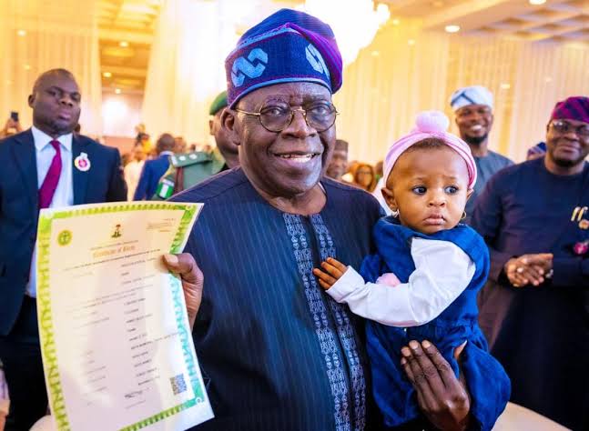 President Bola Tinubu holding a Nigerian child