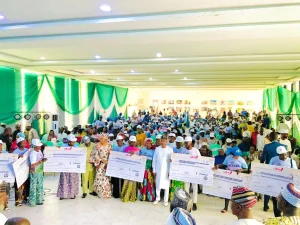 Gov. Ahmed Ododo of Kogi in a group photograph with CFR beneficiaries on Wednesday in Lokoja.