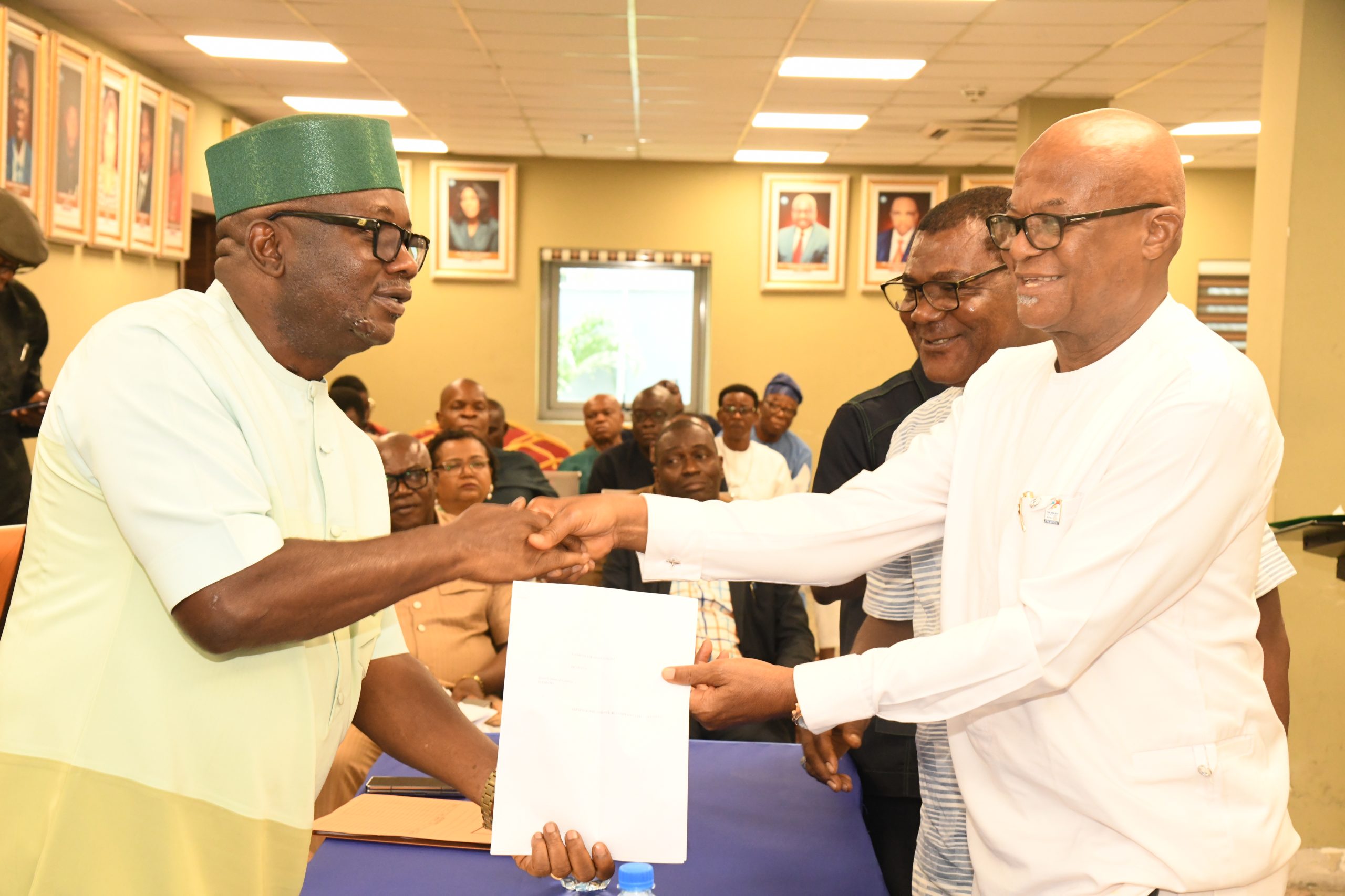 The Executive Director, Projects, Sir Victor Antai (left), presenting documents to one of the farmers from Abia State, Dr Paul Mbah, during the onboarding Programme for the empowerment of the farmers at the NDDC Headquarters in Port Harcourt.