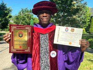 Mr Emmanuel Ahmadu, a Nigerian graduate in a photograph displaying his two honorary doctorate degrees in United States of America.