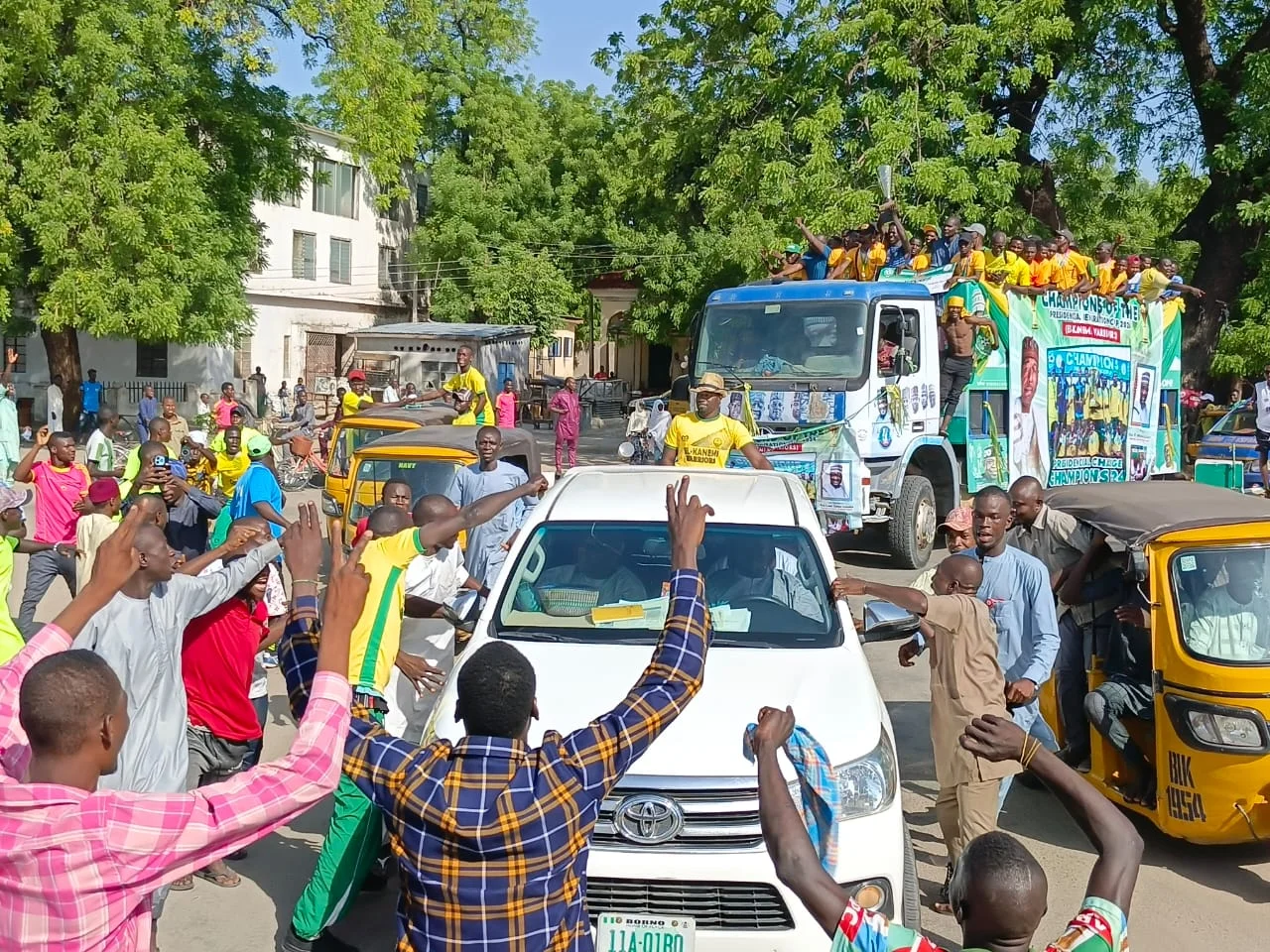 Some football fans celebrating with members of El-Kaneni Warriors FC on streets of Maiduguri