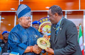 Managing Director of NELFUND, Mr Akintunde Sawyer, presenting the award to Osun State Governor, Ademola Adeleke in Osogbo