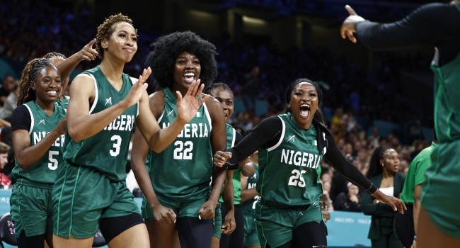 Nigeria’s #05 Olaoluwatomi Oluwayemisi Taiwo, Nigeria’s #03 Pallas Kunaiyi-Akpanah, Nigeria’s #22 Blessing Ejiofor and Nigeria’s #25 Adebola Adeyeye celebrate after Nigeria completed the third quarter ahead of Canada in the women’s preliminary round group B basketball match