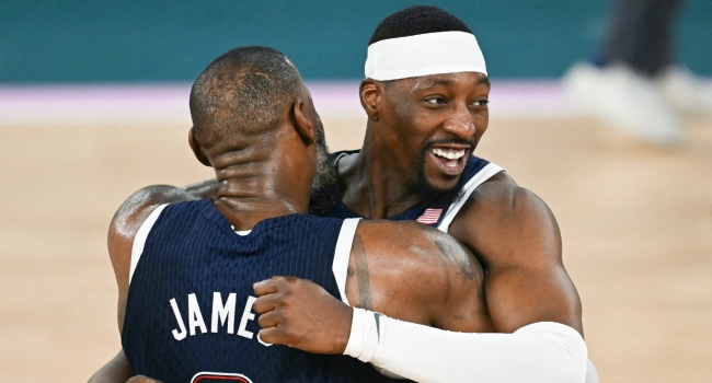 USA’s #13 Bam Adebayo and USA’s #06 LeBron James celebrate winning the men’s Gold Medal basketball match between France and USA during the Paris 2024 Olympic Games at the Bercy Arena in Paris on August 10, 2024. (Photo by Paul ELLIS / AFP)
