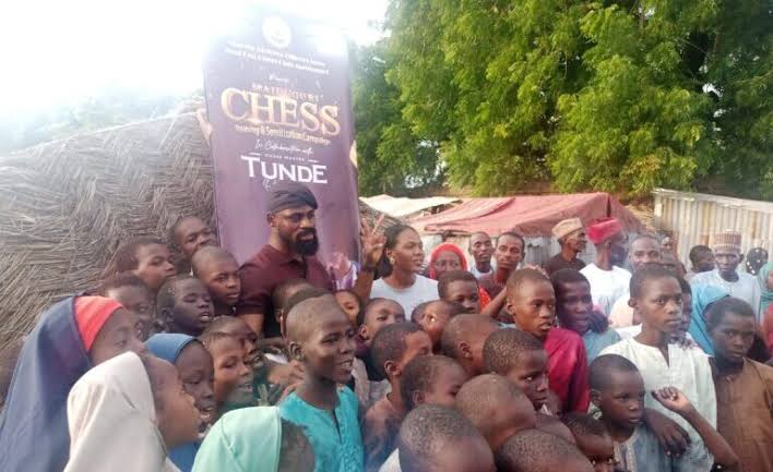 Guinness record holder, Tunde Onakoya in a group picture with children chess players at a displaced persons’ camp in Bolori ward, Maiduguri.
