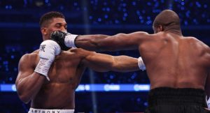 Britain’s Daniel Dubois (R) throws a punch at Britain’s Anthony Joshua during their heavyweight boxing match for the IBF world title at Wembley Stadium in London on September 21, 2024. (Photo by Adrian Dennis / AFP)