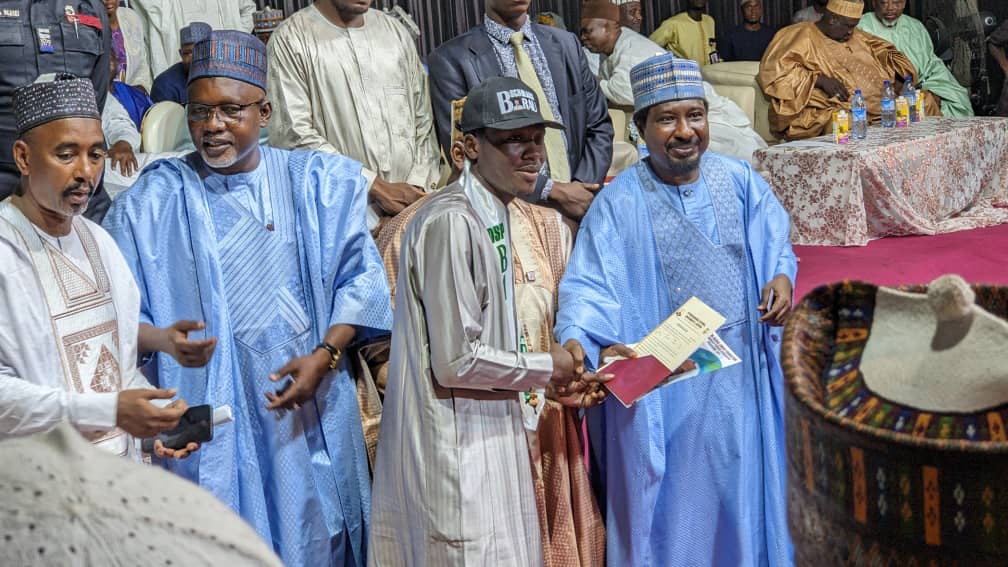 Senator Barau presenting Letters of Admission to the beneficiaries in Kano on Monday.