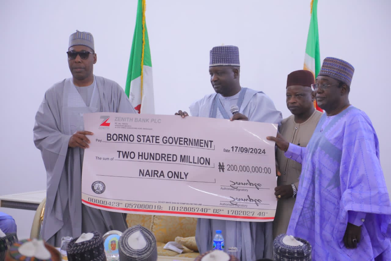 From left: Governor Zulum receives a cheque of N200 million from his Deputy, Dr Umar Kadafur donated by people of Southern Borno to assist in managing the effect of the flood disaster on Tuesday.