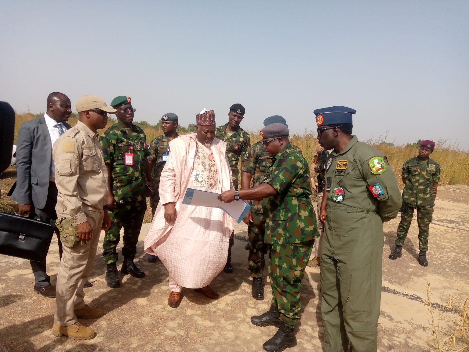 Minister of Defence, Alhaji Badaru Abubakar surrounded by military personnel during the tour