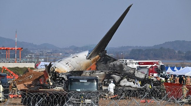 Firefighters and rescue personnel work near the wreckage of a Jeju Air Boeing 737-800 series aircraft after the plane crashed and burst into flames at Muan International Airport in South Jeolla Province, some 288 kilometres southwest of Seoul on December 29, 2024. (Photo by JUNG YEON-JE / AFP)