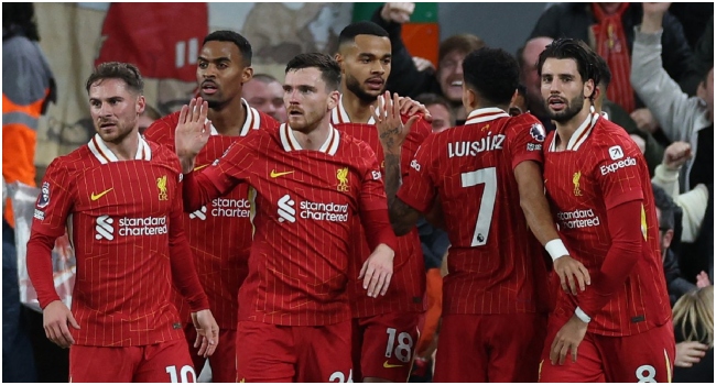 Liverpool’s Dutch striker #18 Cody Gakpo (C) celebrates with teammates after scoring the opening goal of the English Premier League football match between Liverpool and Manchester City at Anfield in Liverpool, north west England on December 1, 2024. (Photo by Adrian Dennis / AFP)