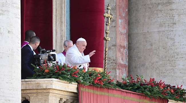 Pope Francis waves from the main balcony of St. Peter’s basilica to deliver the Urbi et Orbi message and blessing to the city and the world as part of Christmas celebrations, at St Peter’s square in the Vatican on December 25, 2024. (Photo by Tiziana FABI / AFP)