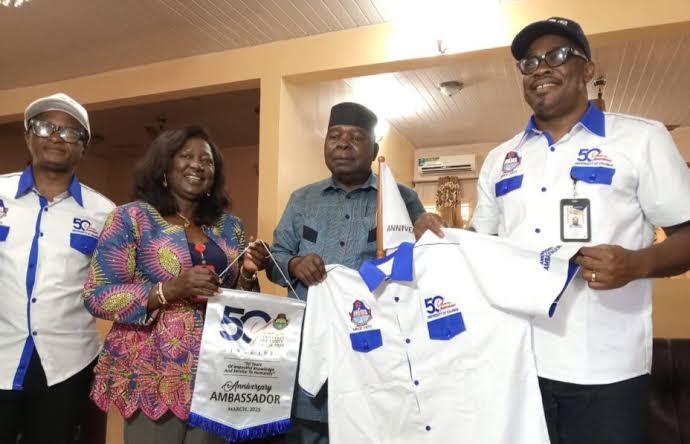 L-R: VC of UniCal, Prof. Florence Obi, Pro Chancellor of UniCal, D.I.G. Udom Ekpoudom and Chairman of UniCal at 50 Anniversary Committee, Prof. Eyong Eyong on Wednesday during the presentation of the anniversary flag to the pro Chancellor in Calabar