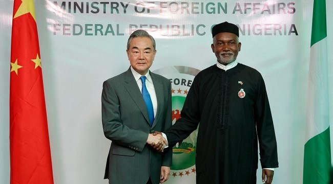 Chinese Foreign Minister Wang Yi (L) shakes hands with Nigeria’s Foreign Affairs Minister Yusuf Tuggar (R) during Minister Wang’s diplomatic visit to Abuja on January 9, 2025. (Photo by Kola Sulaimon / AFP)