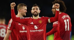 Manchester United’s Portuguese midfielder #08 Bruno Fernandes celebrates scoring their third goal during the English Premier League football match between Leicester City and Manchester United at King Power Stadium in Leicester, central England on March 16, 2025. (Photo by Adrian Dennis / AFP)
