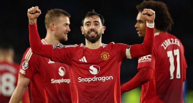 Manchester United’s Portuguese midfielder #08 Bruno Fernandes celebrates scoring their third goal during the English Premier League football match between Leicester City and Manchester United at King Power Stadium in Leicester, central England on March 16, 2025. (Photo by Adrian Dennis / AFP)