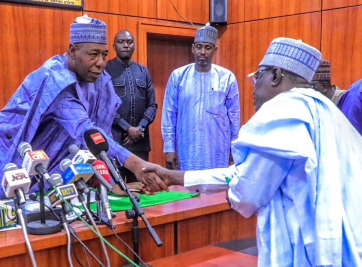Borno State Governor, Babagana Umara Zulum (right) welcomes Dr. Mohammed Aminu Ghuluze, the newly appointed Head of the State's Civil Service (left), during the swearing-in ceremony in Maiduguri.