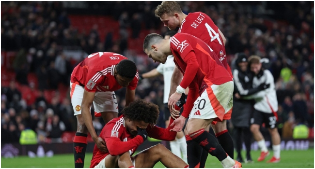 Manchester United’s Dutch striker #11 Joshua Zirkzee (C) is consoled by teammates after missing the final penalty in the penalty shoot-out in the English FA Cup fifth round football match between Manchester United and Fulham at Old Trafford in Manchester, north west England, on March 2, 2025. Fulham won the game 4-3 on penalties after finishing 1-1 after extra time. (Photo by Darren Staples / AFP)