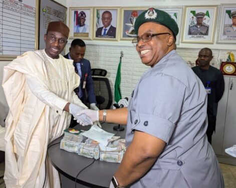 The Acting Director, Lagos office 2 of the EFCC, Mr Ahmed Ghali while receiving the suspect and the foreign currencies from the Controller in charge of Murtala Muhammed International (MMIA) Airport Command Comptroller Effiong Harrison at the MMIA Lagos on Friday.