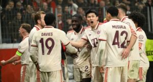 Bayern Munich’s Canadian defender #19 Alphonso Davies (3rd L) celebrates after scoring the 0-2 goal with team mates during the EFA Champions League last 16, second leg, football match between Bayer Leverkusen and Bayern Munich in Leverkusen, western Germany on March 11, 2025. (Photo by INA FASSBENDER / AFP)