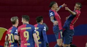 Barcelona’s Brazilian forward #11 Raphinha (2R) celebrates with Barcelona’s Spanish forward #19 Lamine Yamal (R) after scoring the opening goal during the UEFA Champions League Round of 16 second leg football match between FC Barcelona and SL Benfica at the Estadi Olimpic Lluis Companys in Barcelona on March 11, 2025. (Photo by LLUIS GENE / AFP)