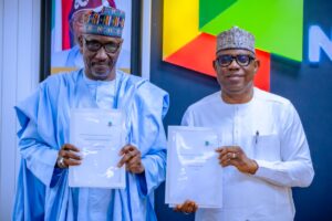 R-L:New Group CEO NNPC Ltd, Mr. Bayo Ojulari and his predecessor, Mr. Mele Kyari display handover notes during a brief handover ceremony held at the NNPC Towers, Abuja on Friday.