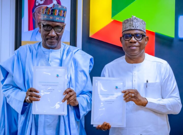 R-L:New Group CEO NNPC Ltd, Mr. Bayo Ojulari and his predecessor, Mr. Mele Kyari display handover notes during a brief handover ceremony held at the NNPC Towers, Abuja on Friday.