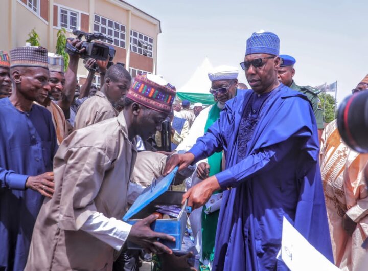 Borno State Governor, Babagana Zulum handling over working tools to one of the beneficiaries
